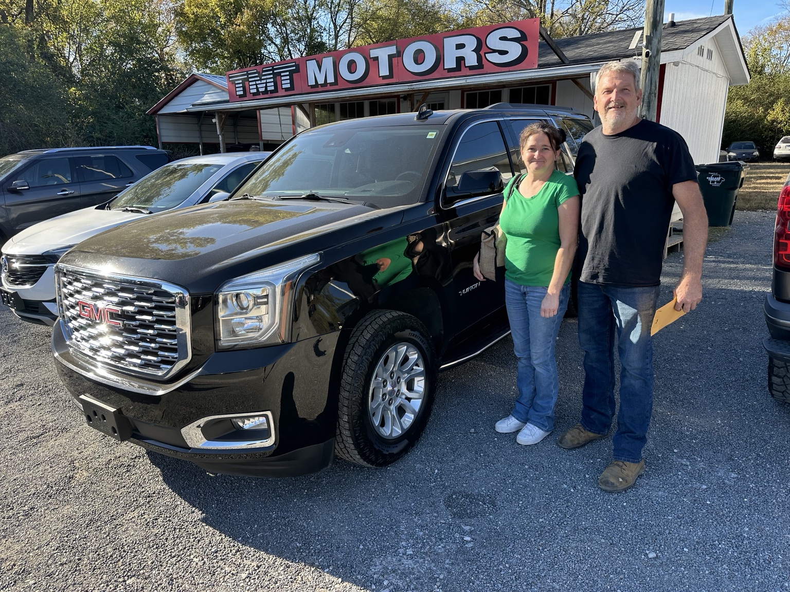 April & Albert with their 2020 GMC Yukon SLT purchased from TMT Motors