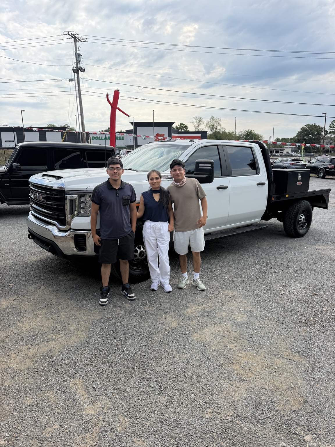Elliot with their 2020 GMC Sierra 2500HD W/T Flatbed purchased from TMT Motors